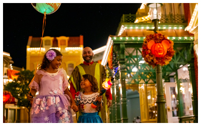 people enjoying a nighttime on main street at Mickey's Not-So-Scary Halloween Party