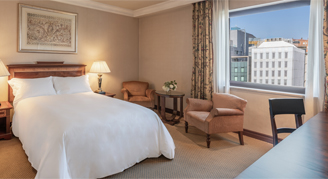 Classic room featuring double bed, chair, and desk area