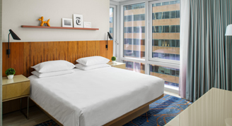 Image of a single bed in a High-Floor Skyline-View Suite.