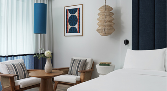 Photo of two chairs and a small table in a hotel room.