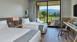 Image of two beds in a Vineyard-View Room with Balcony.