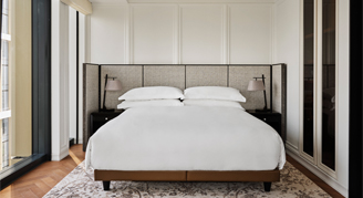 Image of a single bed on a carpet in a Corner Room.