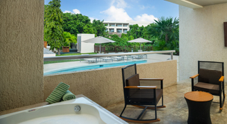 A view of the balcony jacuzzi and seating area overlooking the swim-up pool.