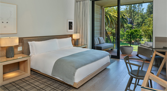 Image of a single bed in a Deluxe Streamside Room with Balcony.