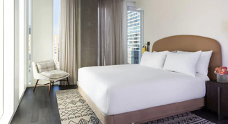 Photo of hotel room with large windows.