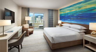 Image of a bed, work area and window in a City-View Room.