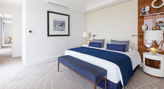 Photo of hotel suite bedroom with king-sized bed.