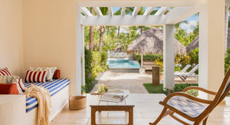 A view of a private terrace with a glimpse of the pool.