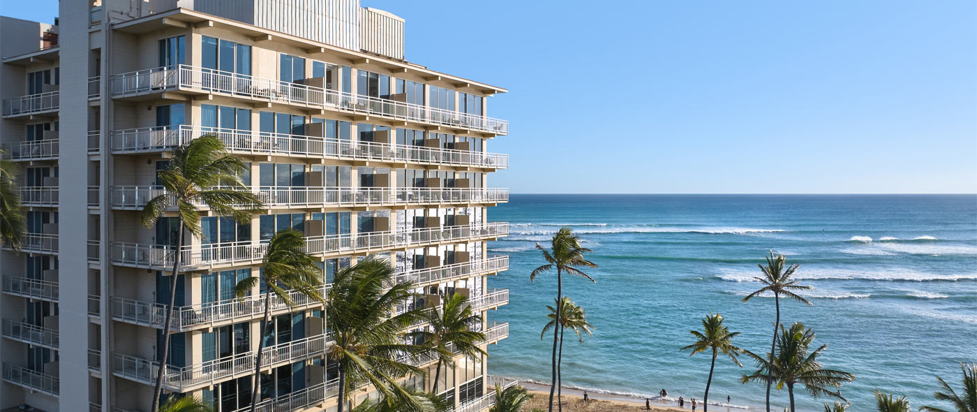 Kaimana Beach Hotel exterior with ocean in background
