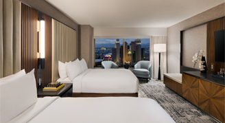 Image of two beds and a large window in a Restore MGM Room.