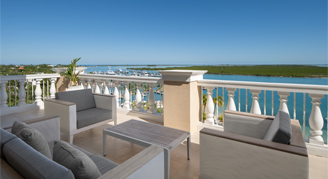Photo of outdoor terrace with seats and ocean view.