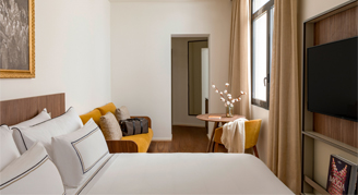 Photo of hotel room a bed and small sitting area.
