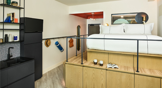 Interior view of the Catbird Studio featuring an elevated king bed.