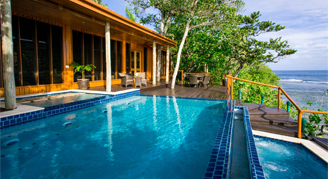 A view from the side of the infinity pool in front of Namale's Grand Villa looking out towards the ocean.