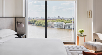 Image of a single bed by a window in a Deluxe River-View Park Suite.