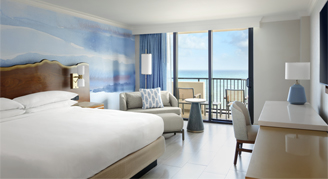 An oceanfront room featuring a king bed and a balcony.