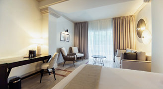 Junior suite  featuring a king-size bed overlooking the ocean.