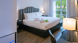 Image of the king bed with tray of amenities.