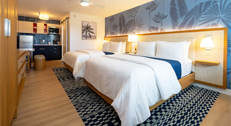 Image of two beds in a Deluxe Suite.