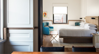 Image of table and bed in a Signature Suite.