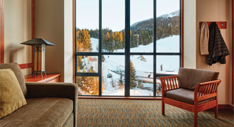 Room with  a large window, chair and couch.