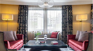 Presidential suite dining area with two couches and a table