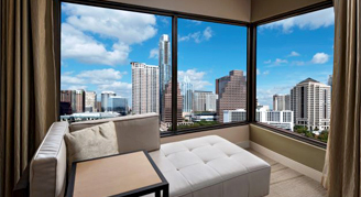 Image of a sofa bed overlooking the city in a Lake-View Corner Room.