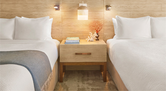 Image of two beds in a Waikiki-Mountain-View Room.