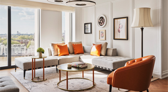 Image of a living area by a window in a Deluxe Park Suite.
