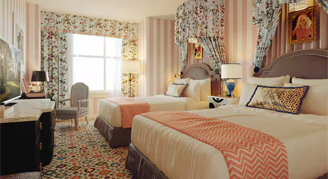 A Two-Bedroom Suite with two queen beds and a window.