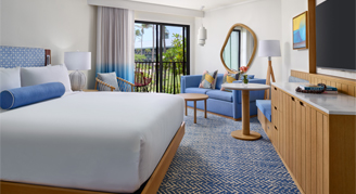 A view with king bed, furniture and balcony with a view.