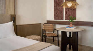 Image of bed and seating area in a Lagoon Area Room.