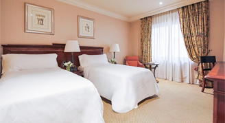 Image of two beds and a window in a Classic Room.