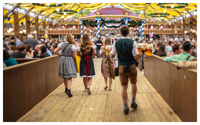 Image of four servers holding beers during Oktoberfest.