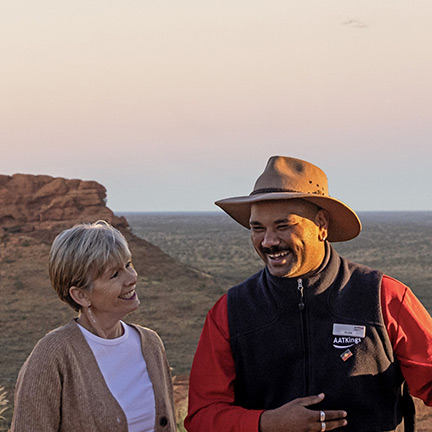 AAT-Kings image of two people having a discussion in a desert environment in Australia