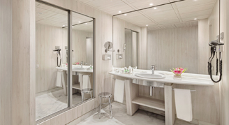 A bathroom with large mirrors.