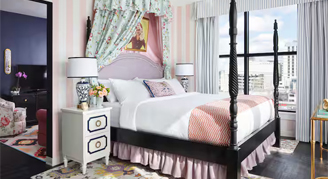 Interior view of the Graduate Suite containing a king bed that offers hearing accessible features