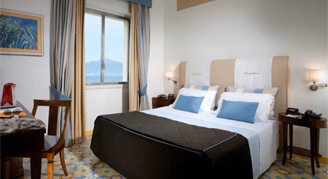 Photo of hotel room with window view of the sea.