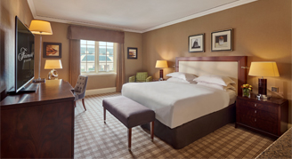 Image of the Fairmont-View Room with one bed, work desk and adjacent window.