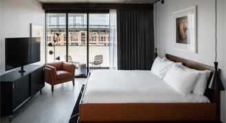 Photo of one king bed and large window view.