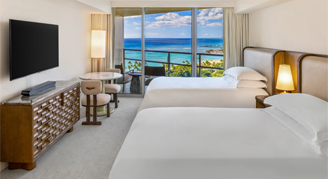 View of two double beds and a view of ocean