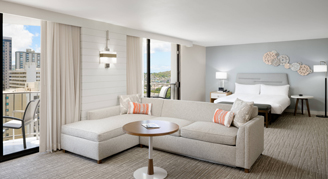 A view of a room featuring a city-view and open concept with seating area and bed.