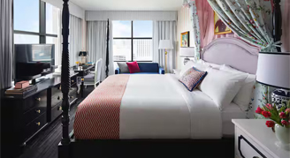 Interior view of the Premium Corner Room featuring city views, a king bed, and accessible features.