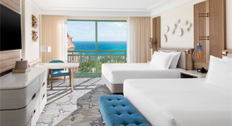 water-view room with two queen beds mounted tv and a view of the ocean