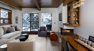 Photo of hotel room living space with fireplace and balcony.