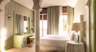 Image of a single bed leading to a balcony in a Venice-View Premium Room.