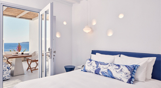 Image of a single bed adjacent to a balcont in a Sea-View Superior Suite.