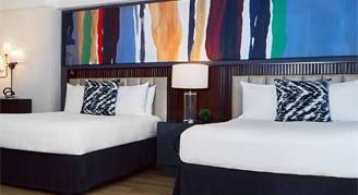 Image of two beds and their bedside table in a Studio Apartment.