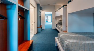The image shows a custom bunk room with blue carpet.