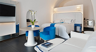 Clean white hotel room with blue accent colors.
